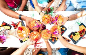 People hands drinking " Sex on the Beach " cocktails