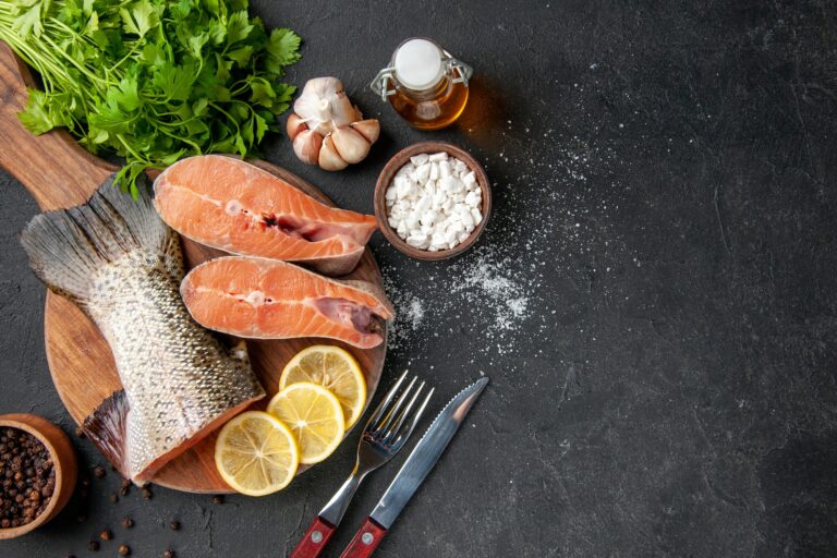 top view fresh fish with lemon slices and greens on dark background ocean seafood meal food meal